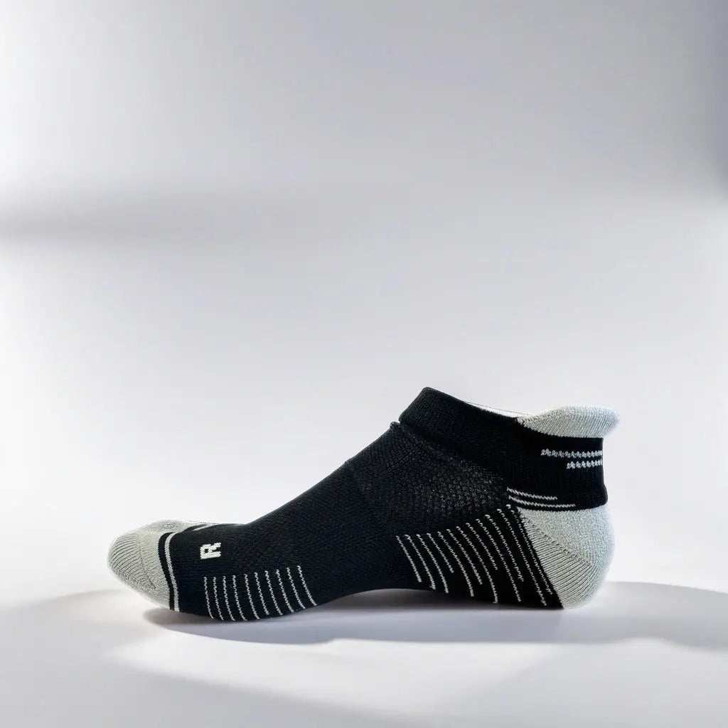 Low cut running socks in black and grey with arch support and ventilation.