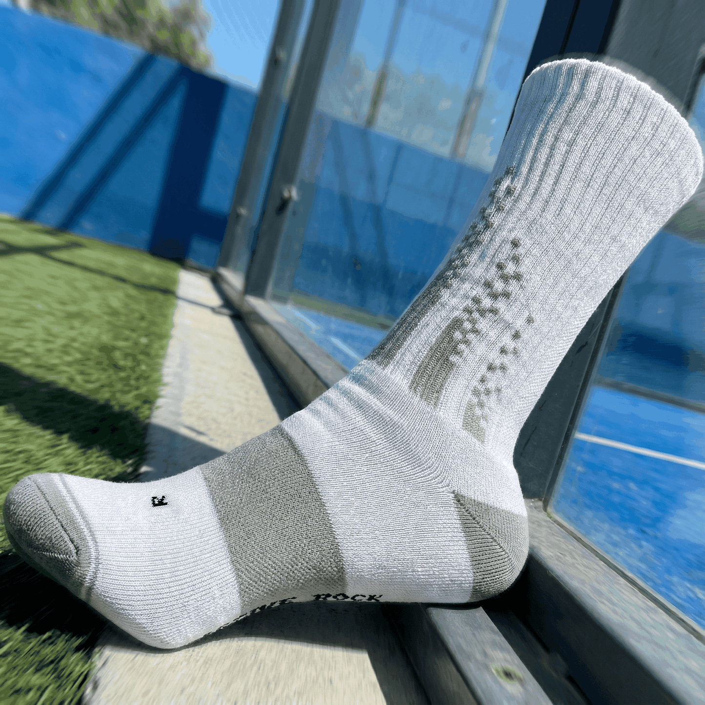 White and grey crew padel socks with cushioning and moisture-wicking fibers for on-court performance